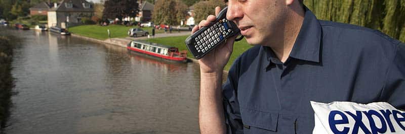 Man Holding A Barcode Scanner To His Ear